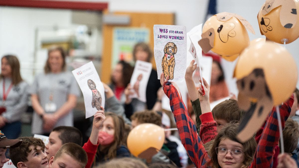 Students holding signs for Winnie at Pup Rally